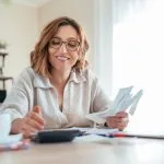 A woman access asset finance for her small business on a laptop