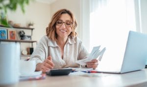 A woman access asset finance for her small business on a laptop