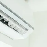 Air conditioning unit mounted to white office wall