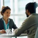 Two people meeting to discuss personal guarantee insurance - a provider and a customer