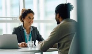 Two people meeting to discuss personal guarantee insurance - a provider and a customer