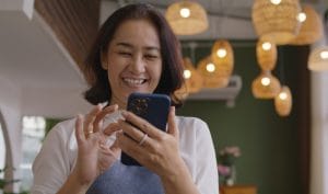 A happy woman access business financial advice on her smartphone