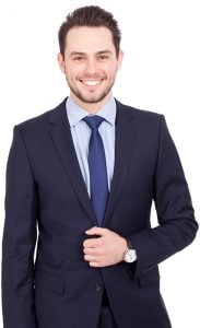 An accountant in a navy blue suit smiling at the camera