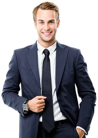 A businessman in a navy blue suit smiling at the camera, whilst holding on to his jacket
