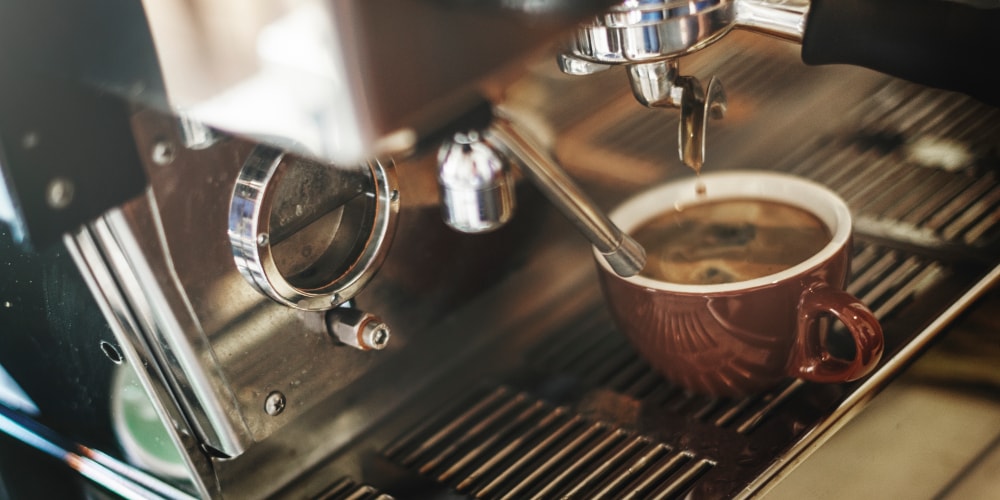 Commercial coffee machine pouring a Caffe Amerciano