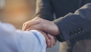 A close up image of two professionals greeting one another