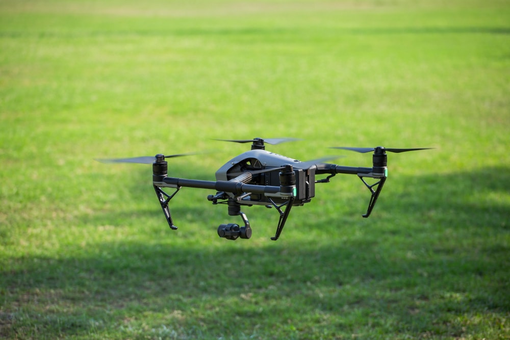 Drone flying low to the ground in field