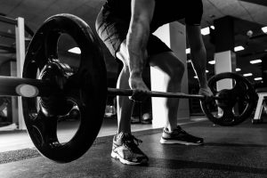 Man dead lifting weights at the gym