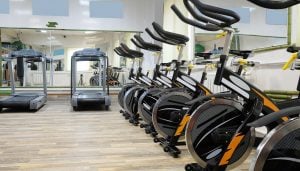 A row of spinning bikes and treadmills in a newly fitted out gym