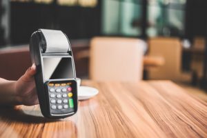 Card machine held by cafe owner