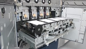 A close up image of an industrial printer showing the internal workings of the machine.