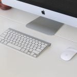 Close up view of an imac sitting on a white, wooden desk