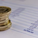 British pound coins on a budget spreadsheet