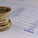 British pound coins on a budget spreadsheet