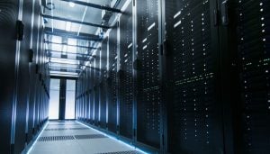 Server room featuring floor to ceiling servers contained in glass cabinets