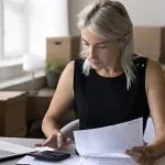 A small business owner conducting her uk business tax calculation