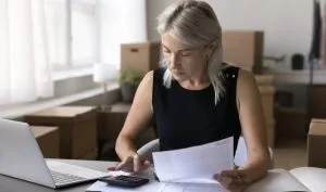 A small business owner conducting her uk business tax calculation