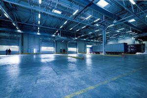 Empty warehouse with lorry departing out of garage door