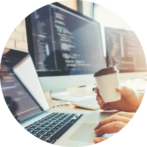 Web developer holding coffee while amending some code